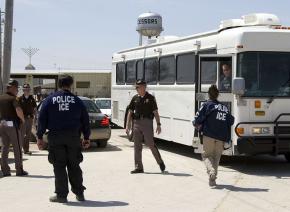 A Homeland Security bus loaded with detainees leaves the Agriprocessors Inc. plant where ICE agents arrested more than 300 people in May 2008
